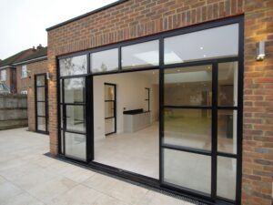 "Interior view of custom-installed bifold doors Walton Surrey home extension"