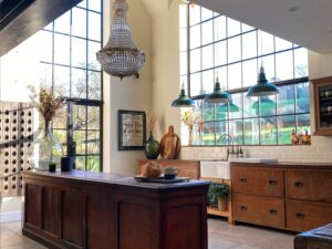 "Stylish aluminium bifold doors open wide to connect a modern Weybridge home with its garden"