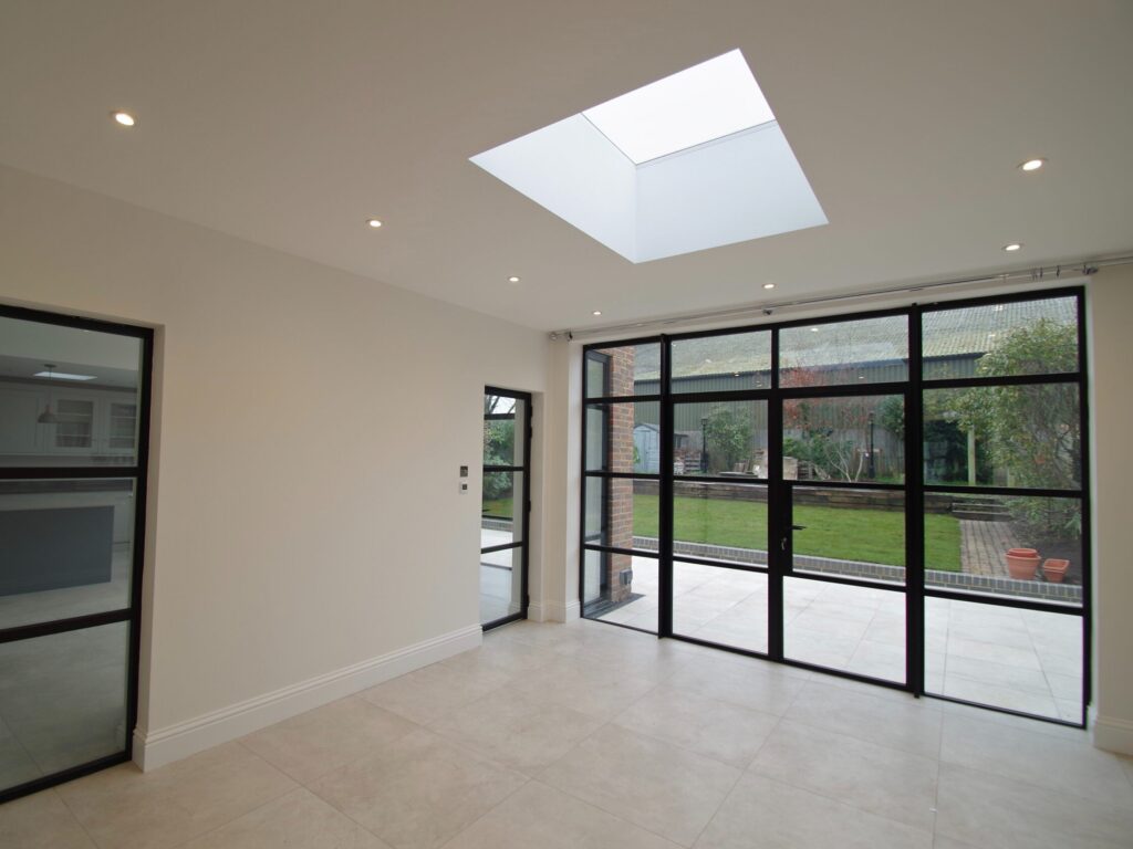 "Modern garden room fitted with bifold doors Walton Surrey by Urban & Grey"